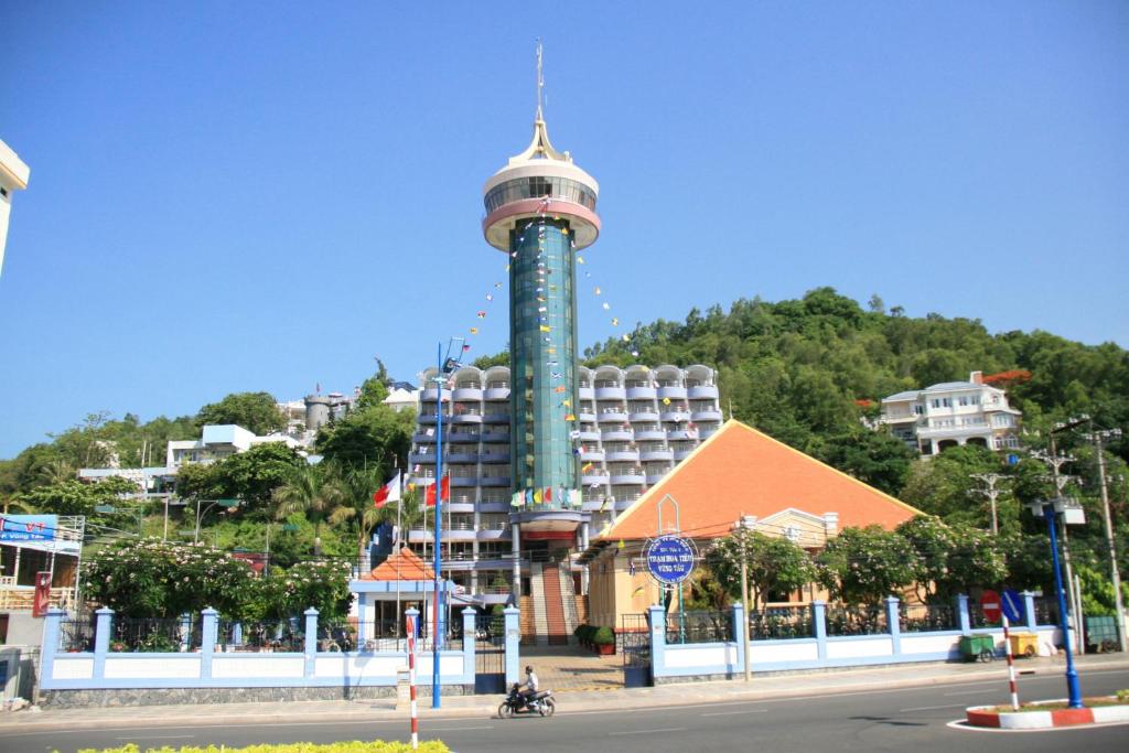 a building with a tower in the middle of a street at Hoa Tieu Guesthouse in Vung Tau