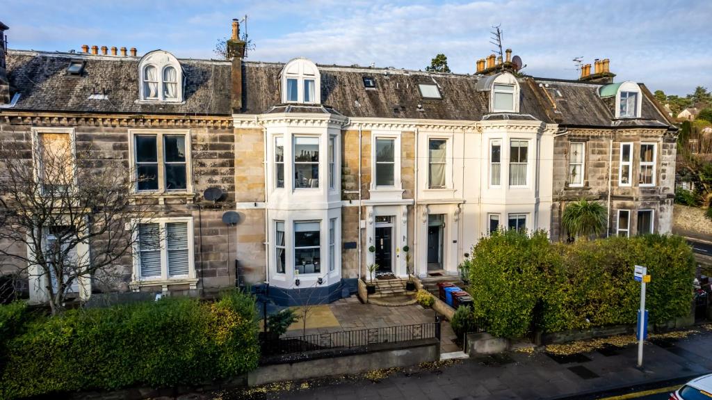 a large brick house with white doors and windows at Casa Fresa - Orchar Suites in Dundee