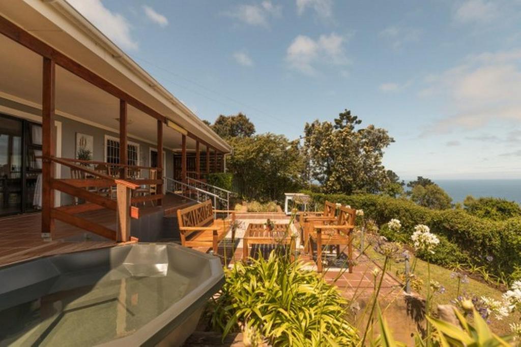 a balcony of a house with a view of the ocean at Victoria Bay Holiday Cottage in George