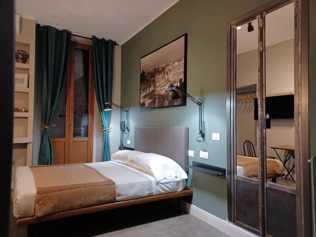a bedroom with a bed and a mirror at Hotel Calypso in Milan