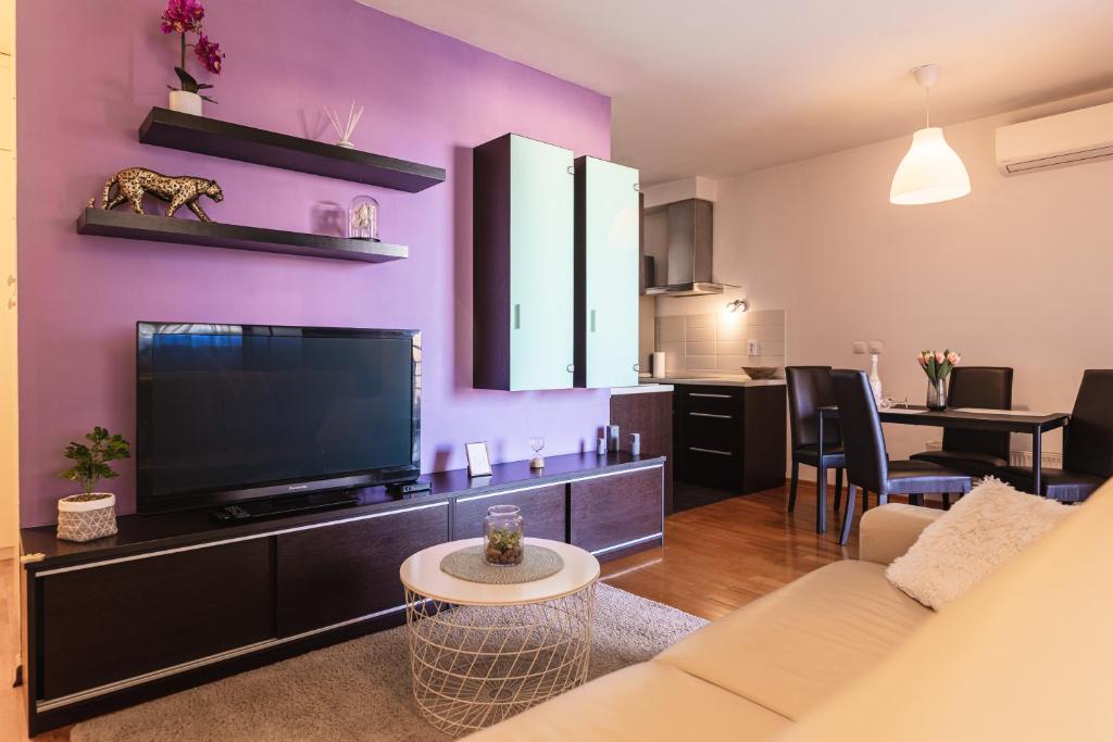 a living room with a couch and a flat screen tv at Flexible SelfCheckIns 29 - Zagreb - Garage - Loggia - New - Apartments Repinc in Zagreb
