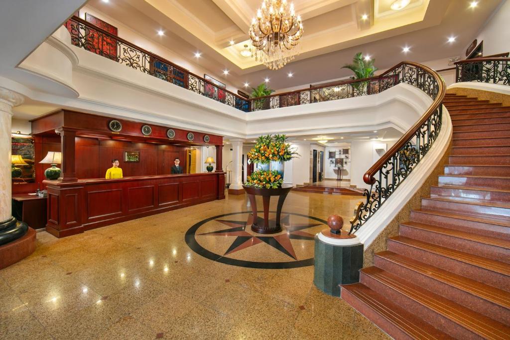 a lobby with a staircase in a hotel at The Tray Hotel Hai Phong in Hai Phong
