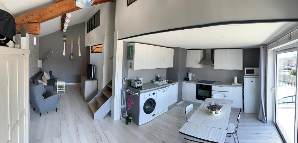 a kitchen and living room with a washing machine at Clos du Cardinal in L'Isle-sur-la-Sorgue