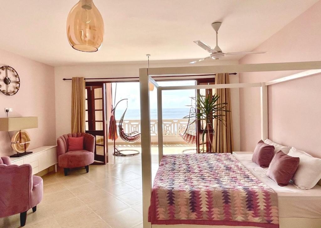 a bedroom with a bed and a view of the ocean at La Mera Ocean-View, 2 Bedroom - Apartment with Pool and NEW renovated Art Style Rooms in Shanzu