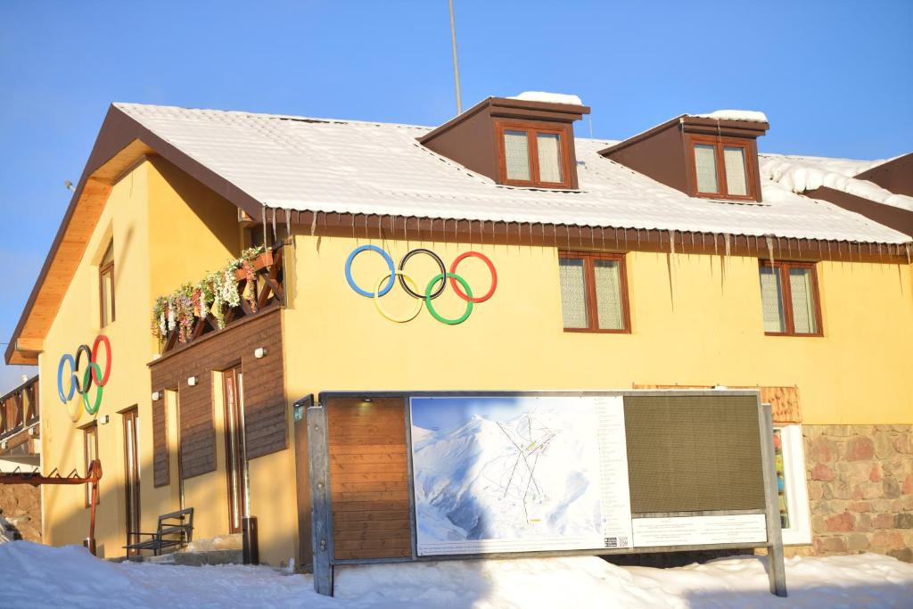 a building with the olympics on it in the snow at OLYMP in Gudauri
