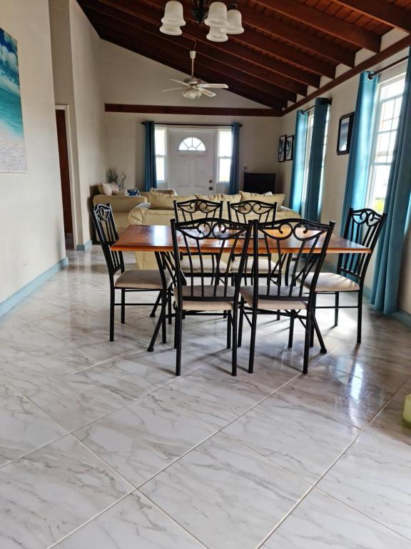 a dining room with a table and chairs at Breezy Apts in Saint Philip