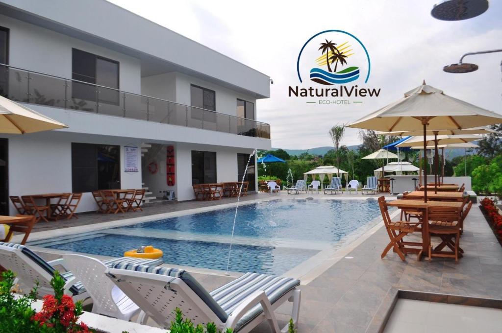 a resort with a swimming pool and a restaurant at Natural View in Melgar