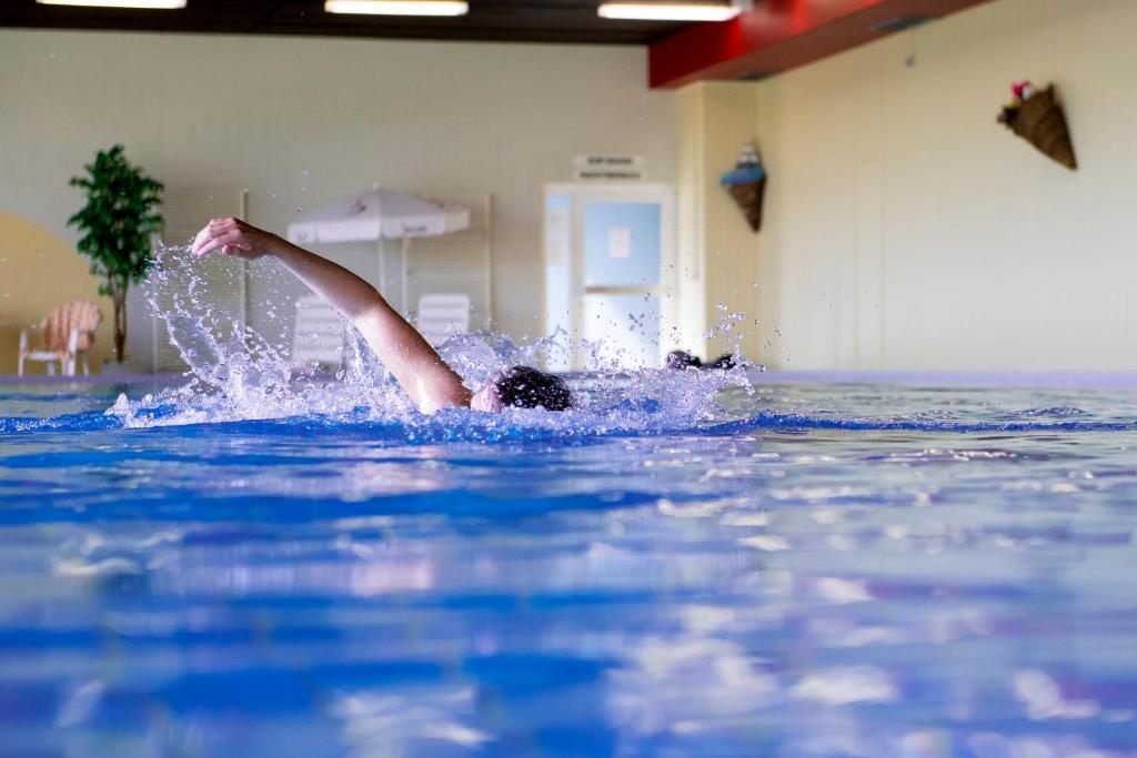 een persoon die in het water van een zwembad valt bij App 365 Panoramic Hohegeiß mit WLan in Braunlage