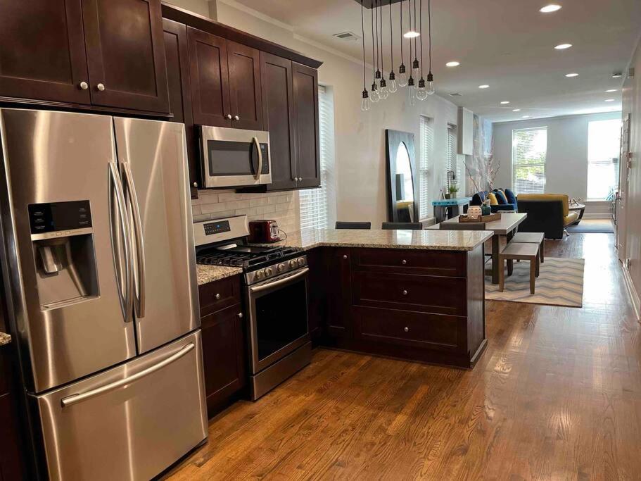 a kitchen with wooden floors and stainless steel appliances at Trendy West Town Flat - 2 bed / 1.5 bath w parking in Chicago
