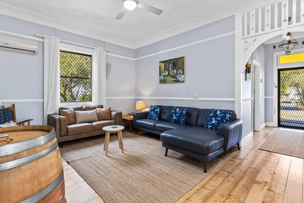 a living room with a couch and a table at HOLIDAYS ON LOVE STREET / HUNTER VALLEY in Cessnock