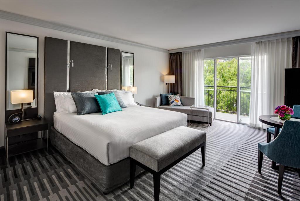 a bedroom with a large bed and a living room at InterContinental Sydney Double Bay by IHG in Sydney