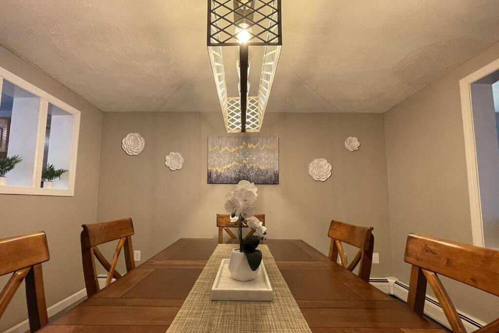 a dining room with a table with a vase of flowers at Spacious Family Lake & Ski House in Windsor