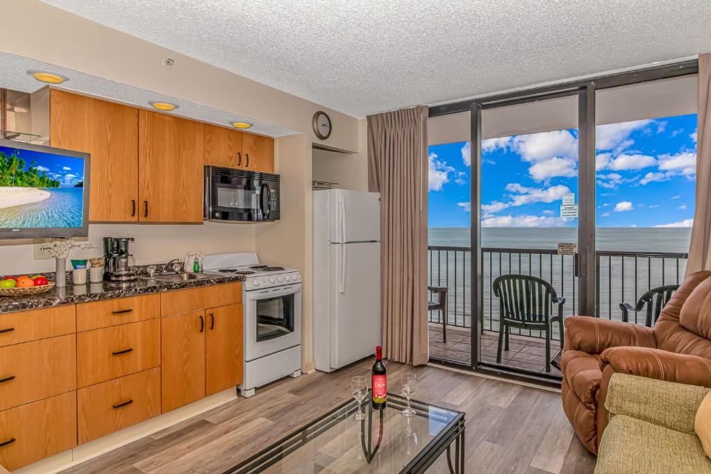 a kitchen with a view of the ocean at Beach Colony Resort Unit 1405 - Beautiful Oceanfront Condo - 1 bedroom, 1 bath - Perfect for 6! in Myrtle Beach