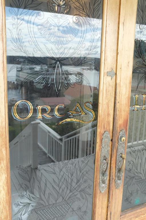 a glass door with a sign that says oneax at Orcas Hotel in Orcas