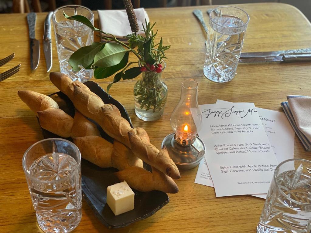 a table with a plate of bread and cheese at Orcas Hotel in Orcas
