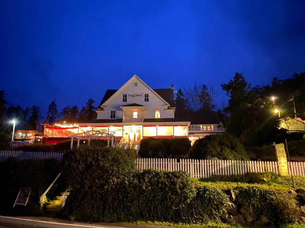 a white house at night with lights on at Orcas Hotel in Orcas