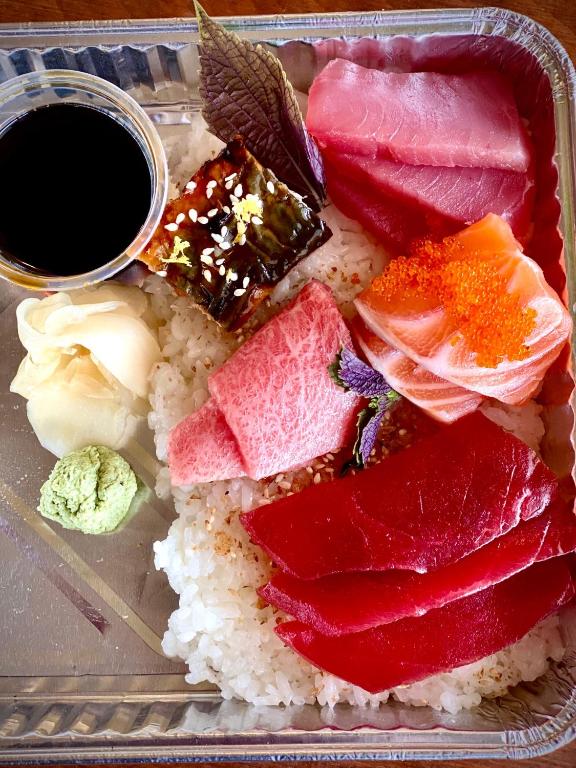 a plate of sushi and rice with a cup of coffee at Orcas Hotel in Orcas