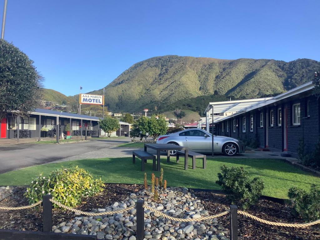 a town with a car parked in front of a building at AAA Marlin Motel in Picton