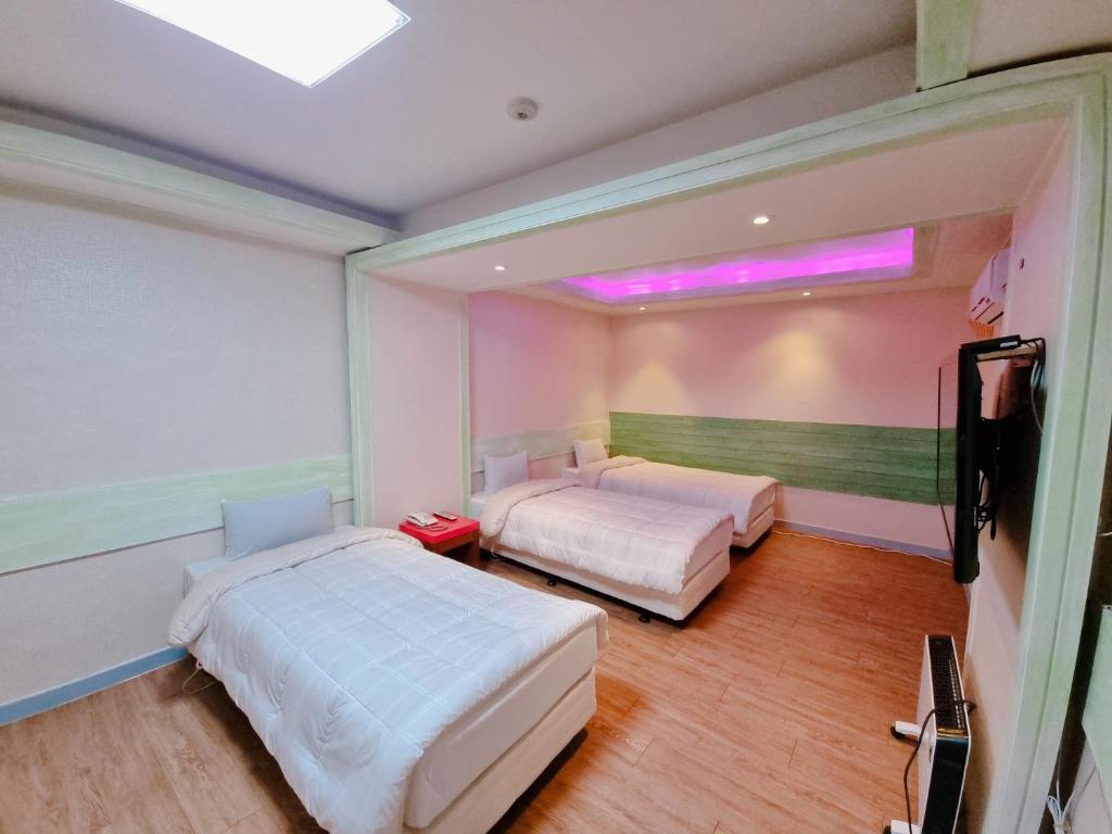 Ένα ή περισσότερα κρεβάτια σε δωμάτιο στο Raemian