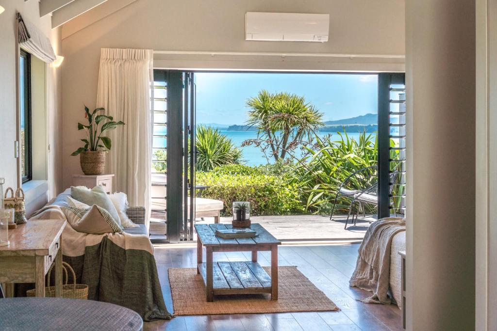 a living room with a view of the ocean at The Moorings Studio Apartments in Oneroa