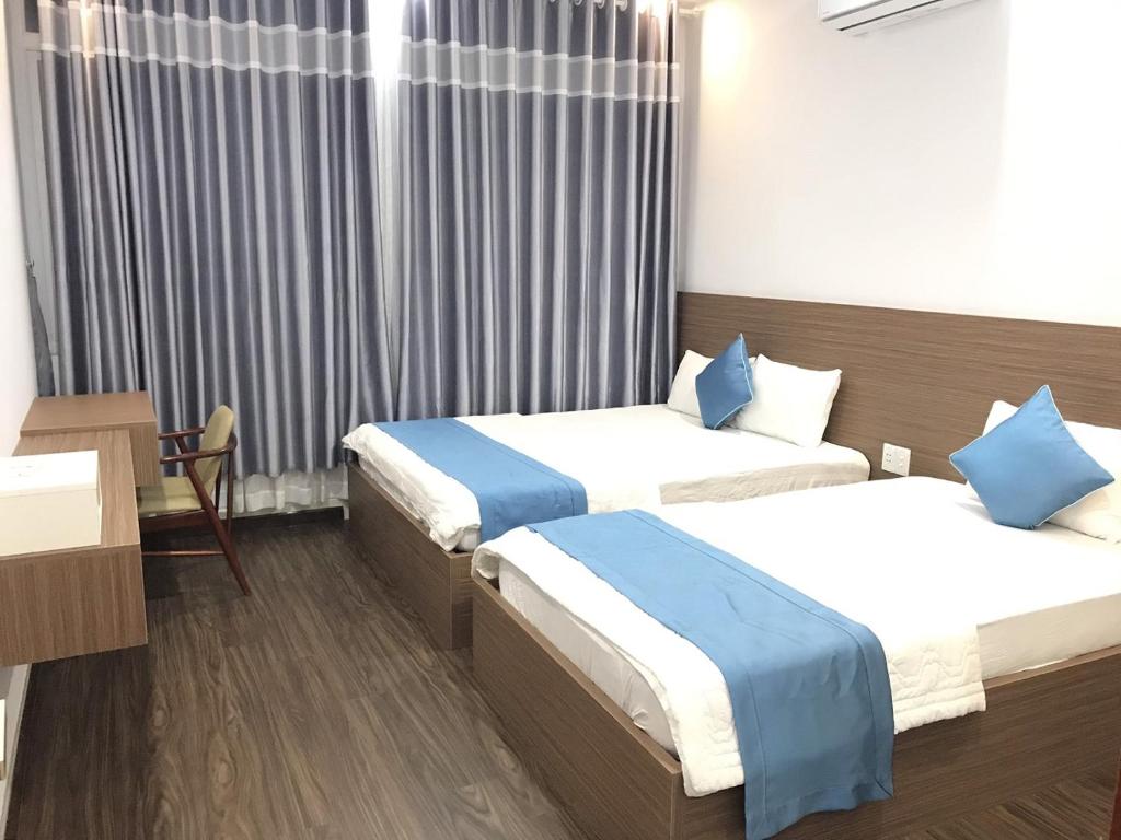 Giường trong phòng chung tại Thanh Binh Hotel Con Dao