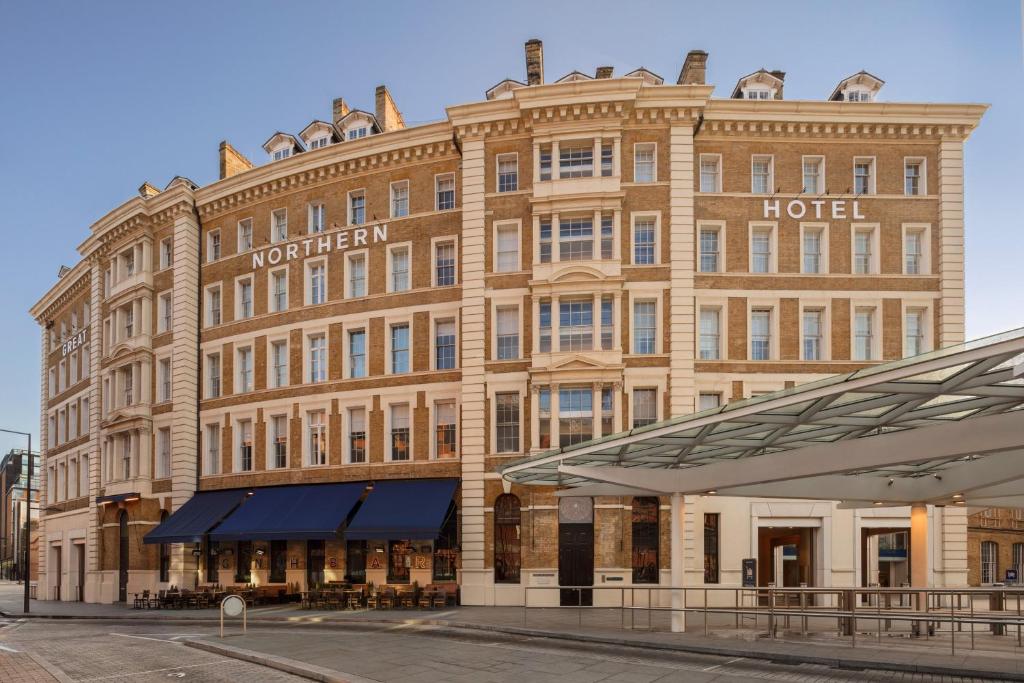 a large building with a clock on the front of it at Great Northern Hotel, A Tribute Portfolio Hotel, London in London