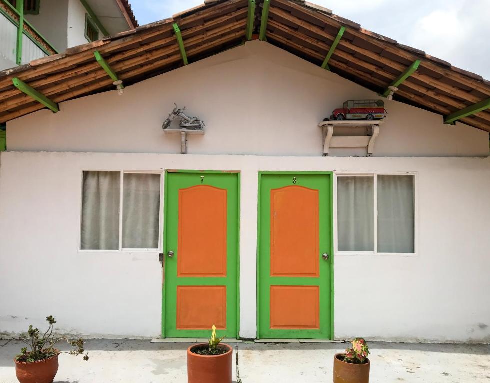 a house with green and orange doors at Room in Guest room - Room with 1 double bed and 2 single beds Number 8 in Rizaralda