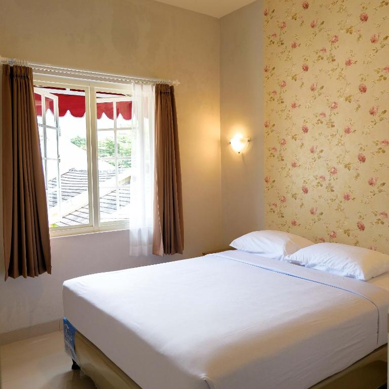 Postel nebo postele na pokoji v ubytování Rosetta Homestay
