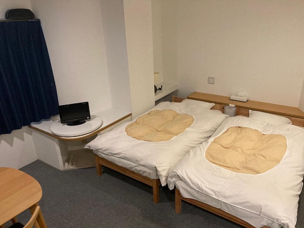Postel nebo postele na pokoji v ubytování J-Hoppers Beppu Guesthouse ジェイホッパーズ別府ゲストハウス