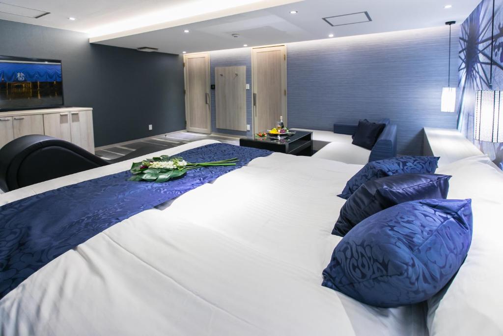 Postel nebo postele na pokoji v ubytování HOTEL 粋