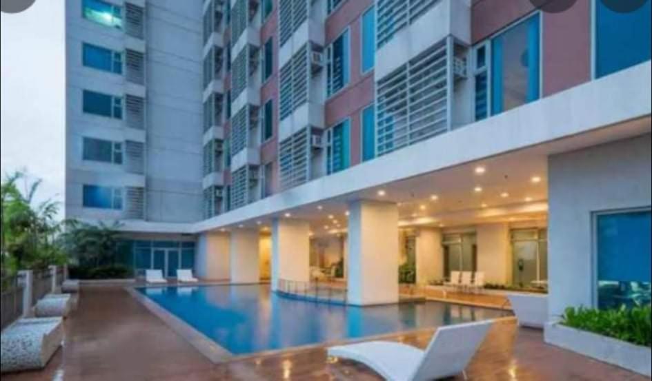 a swimming pool in the middle of a building at JohnStay in Manila