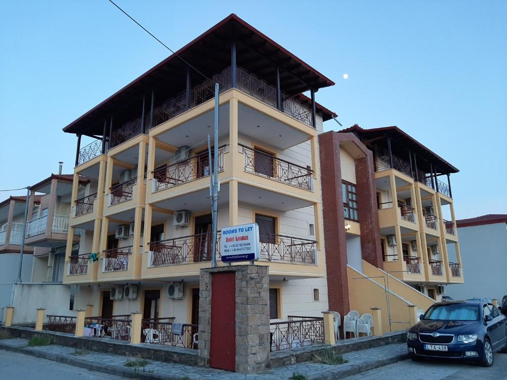 a building with a car parked in front of it at Hotel Kosmas in Sarti