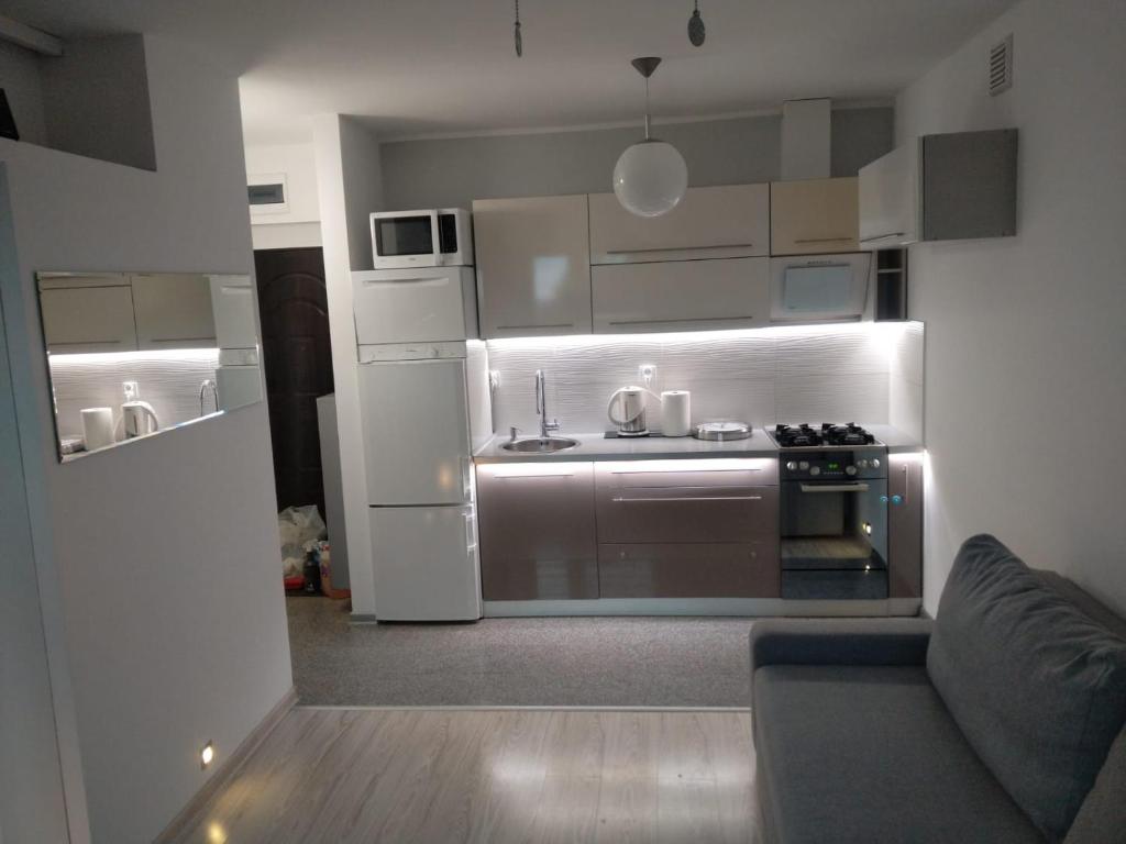 a small kitchen with a stove and a refrigerator at Apartament Ziemia Kłodzka in Kłodzko