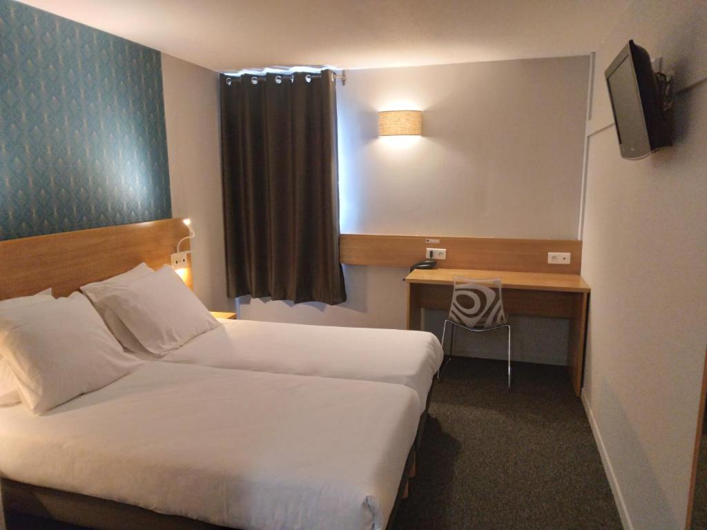 a hotel room with two beds and a desk at Cit&#39;Hotel Hotel Prime - A709 in Saint-Jean-de-Védas