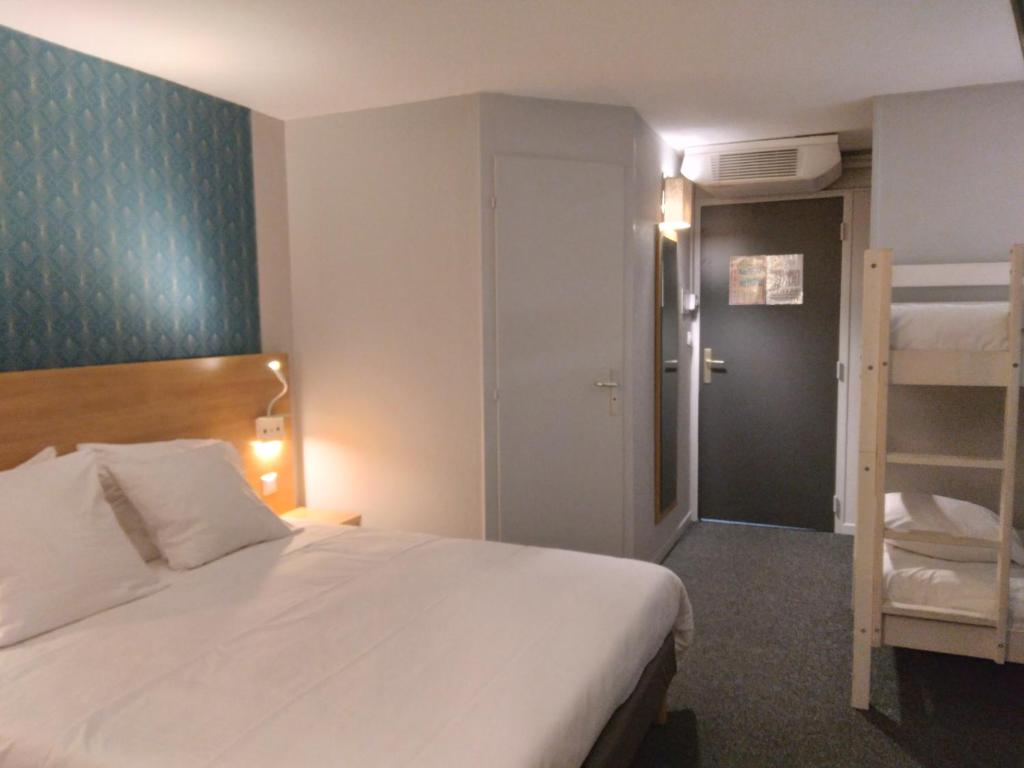 a bedroom with a bed and a bunk bed at Cit&#39;Hotel Hotel Prime - A709 in Saint-Jean-de-Védas