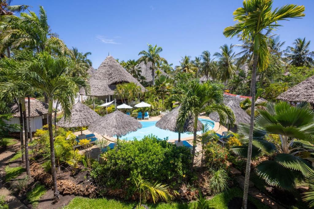 uma vista aérea de um resort com uma piscina e palmeiras em Aestus Villas Resort em Praia de Diani