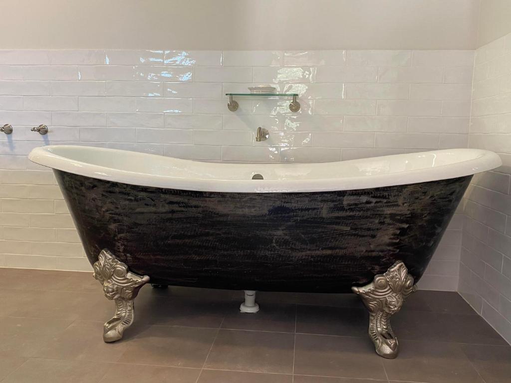 a black and white bath tub in a bathroom at Chez Vous French Farmhouse Villa 3! in Pokolbin
