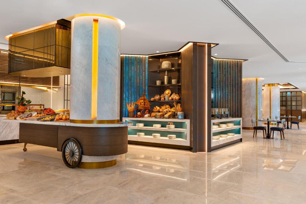 a bakery with a cart in the middle of a room at Taj Exotica Resort & Spa, The Palm, Dubai in Dubai