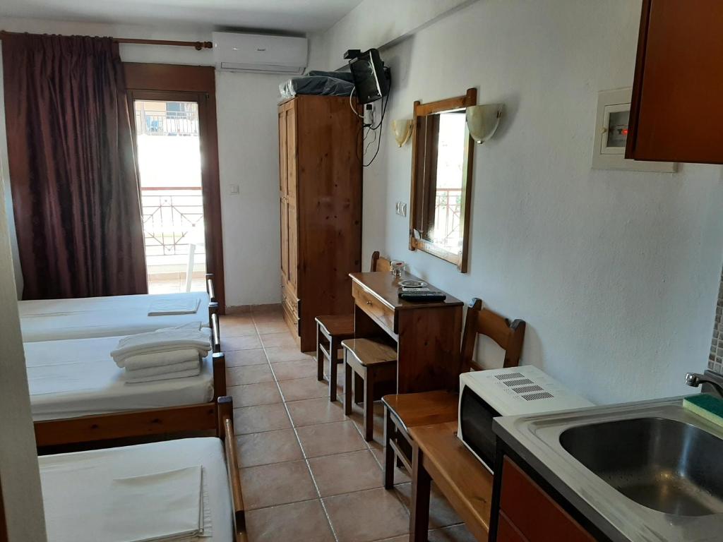 a kitchen with a sink and a counter top at Hotel Kosmas in Sarti