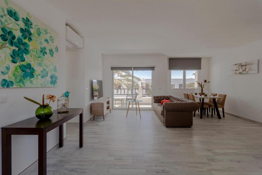 a living room with a couch and a table at Costa Luz Sirens Beach in Los Pocillos