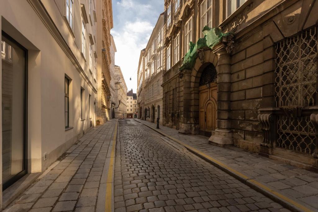 an empty street in a city with buildings at Old Town Vienna in Vienna