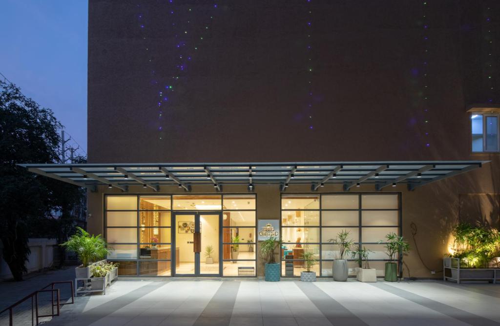 a building with a glass facade at night at Hotel Regal Grand in Bhopal