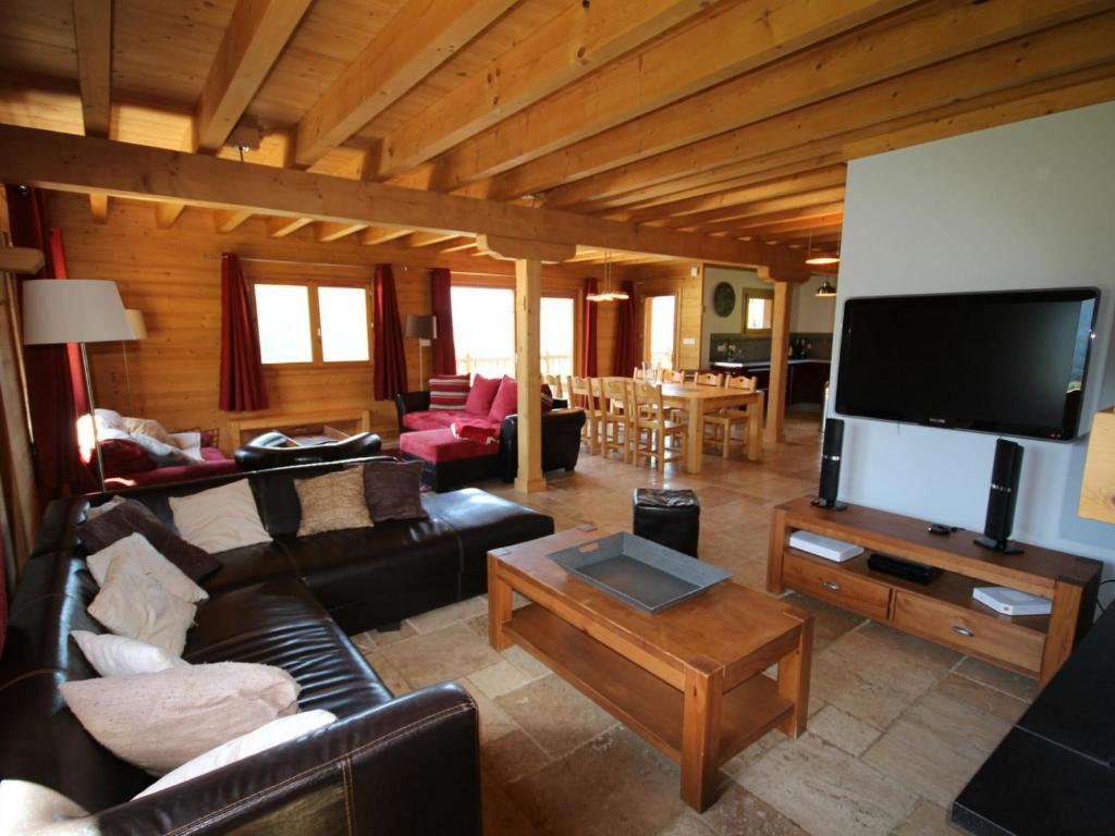 a living room with a couch and a tv at Chalet Hauteluce, 7 pièces, 12 personnes - FR-1-293-55 in Hauteluce