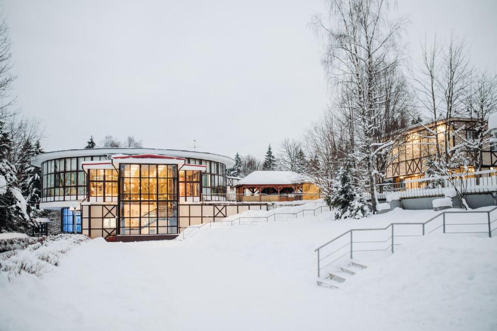 a house in the snow with snow covered trees at LESNOY Park Hotel in Solnechnogorsk