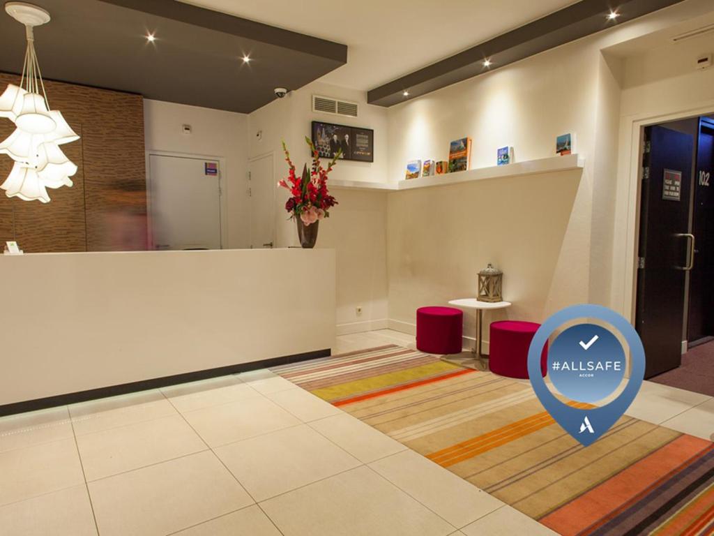 a lobby with a wellness sign in the middle of a room at ibis Styles Amsterdam Amstel in Amsterdam
