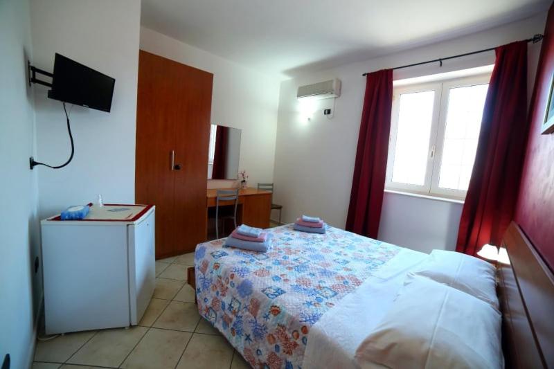 A bed or beds in a room at Maxpensione