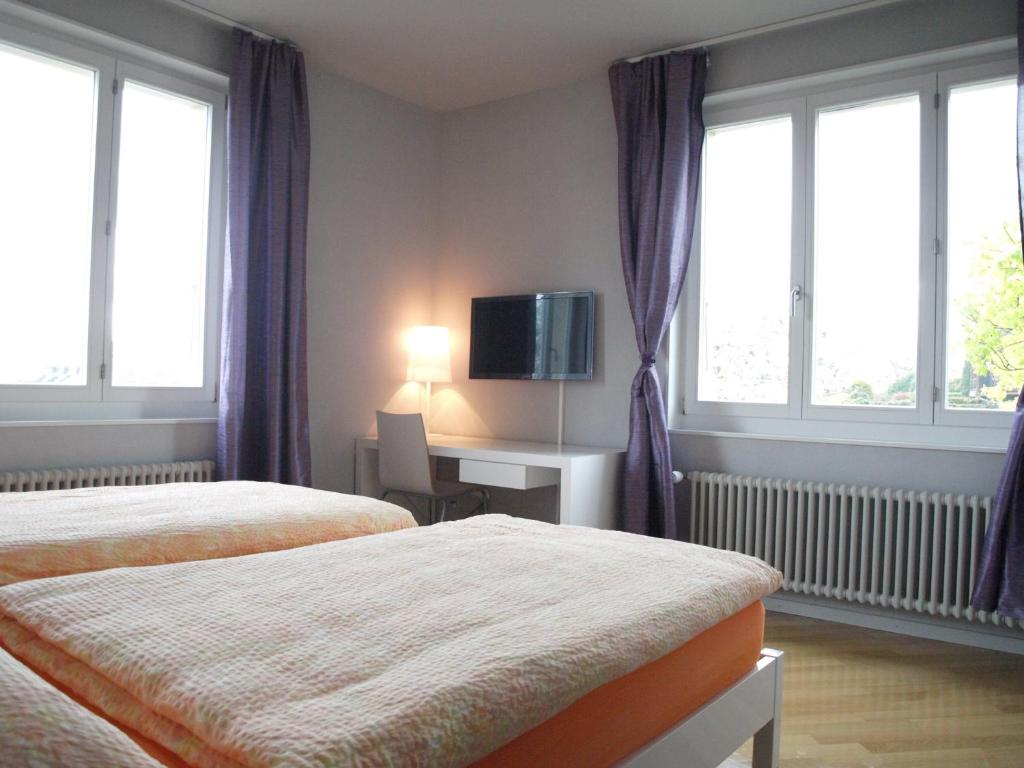 Postel nebo postele na pokoji v ubytování Auberge de Founex
