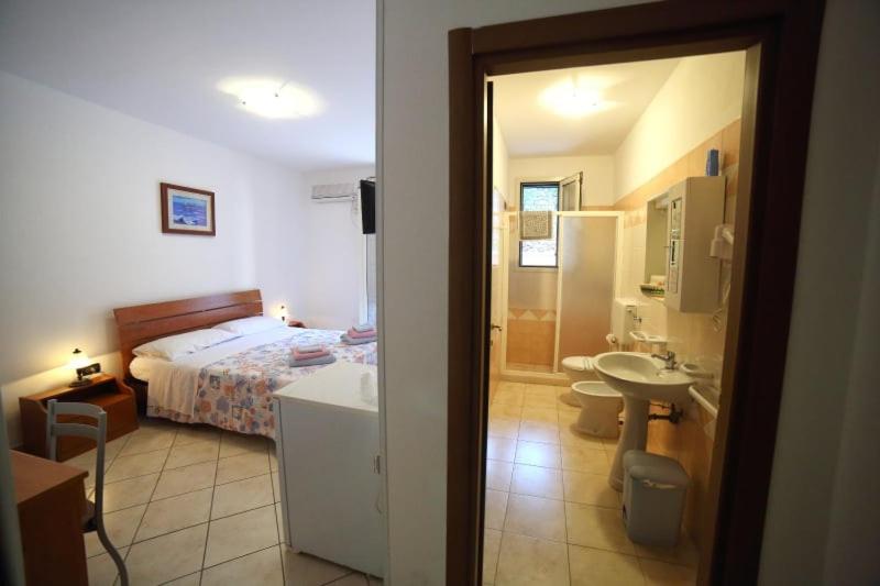 A bed or beds in a room at Maxpensione