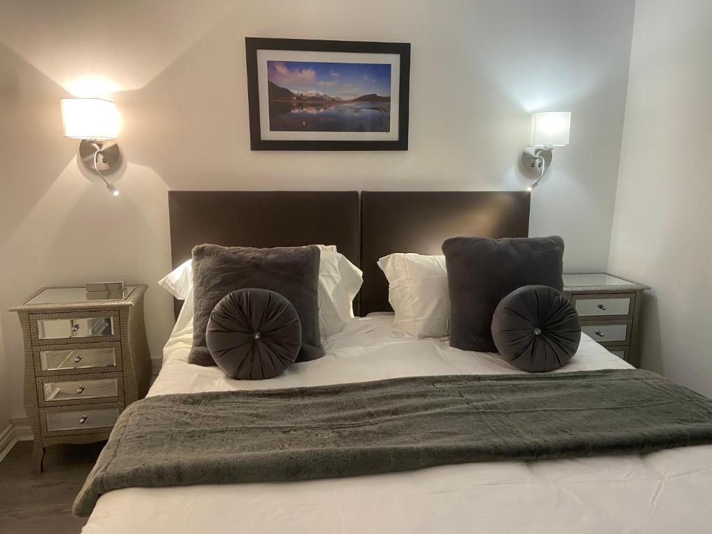 A bed or beds in a room at Bow Serviced Apartments