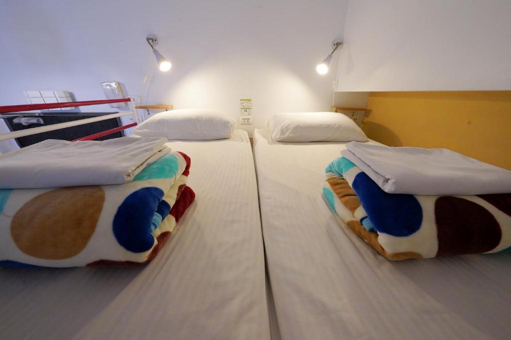 Postel nebo postele na pokoji v ubytování 安蘭居旅店 An Lan Jie Hotel